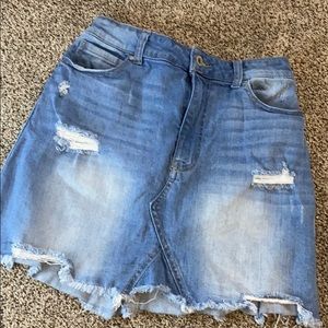 Medium washed distressed jean skirt.